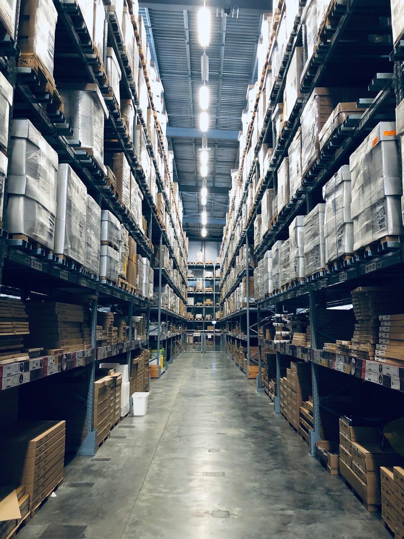 A warehouse aisle stacked with palletised goods